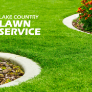 Green lawn with flower beds and text.